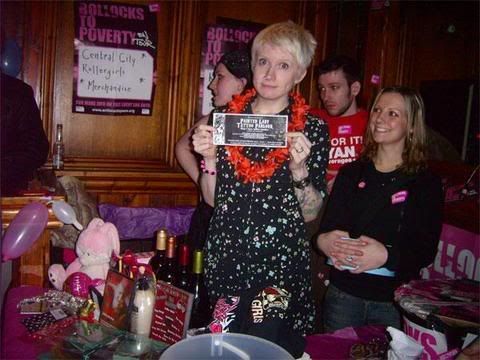 the cornucopia of raffle prizes...and Daisy holding the most coveted of all prizes...the tattoo voucher!